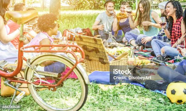 Diverse Culture Friends Making Picnic On City Park Outdoor Young Trendy People Eating Dinner In Backyard Outside Focus On African Hair Girl Youth And Friendship Concept Vintage Retro Filter Stock Photo - Download Image Now