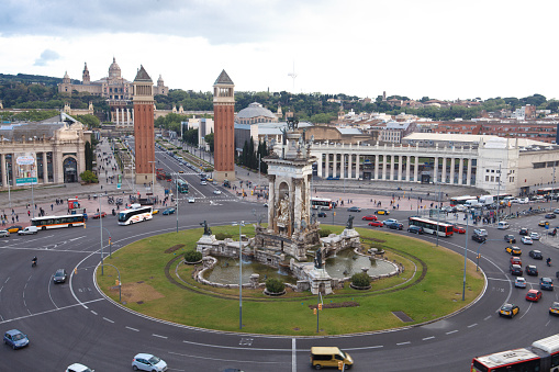 Traffic at one of the most popular squares in Barcelona. The street through the gates lead to the famous Museu Nacional d'Art de Catalunya.