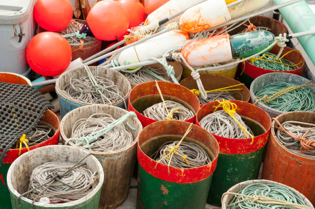 Pails with fishing nets and buoys on a wharf