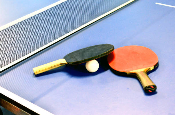 istock Pingpong rackets and ball highlighted on a blue pingpong table 686736966