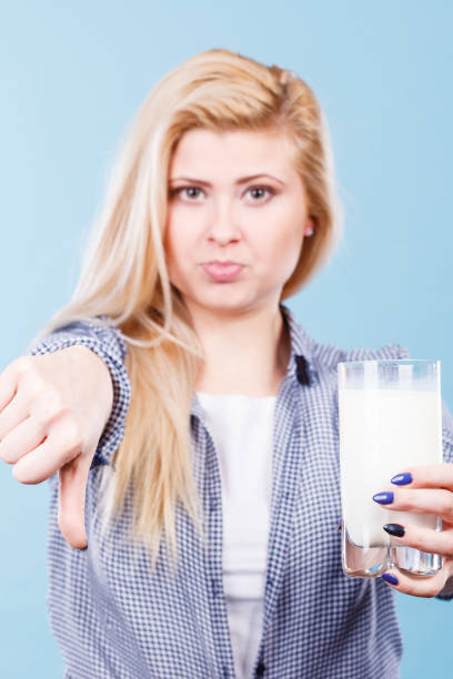 istock Woman holding milk glass showing thumb down 686740452