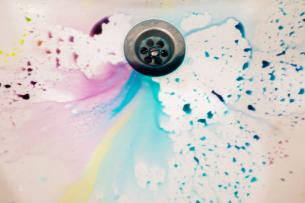 istock in white ceramic sink poured a lot of different colors to paint eggs for Easter beautiful background and almost a rainbow formed in the water 686746682