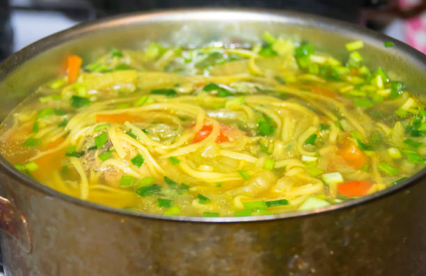 istock Cauldron of yellow chicken soup 686746814