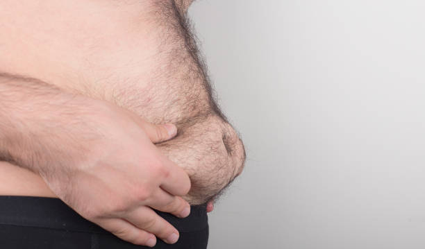 istock Man Pinching the Fat on his Belly 686762602