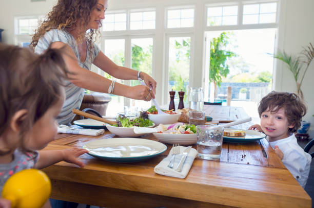 istock Mother serving food at the table. 686765930
