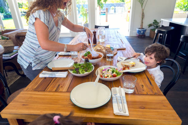 istock Mother serving food at the table. 686765932