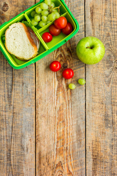 istock school lunch set with apple and vegetables in lunchbox background top view mock up 686780508