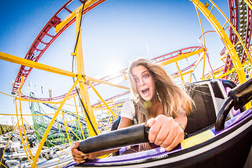 A girl is taking a ride with a rollercoaster at Beer Fest in Munich / Germany.