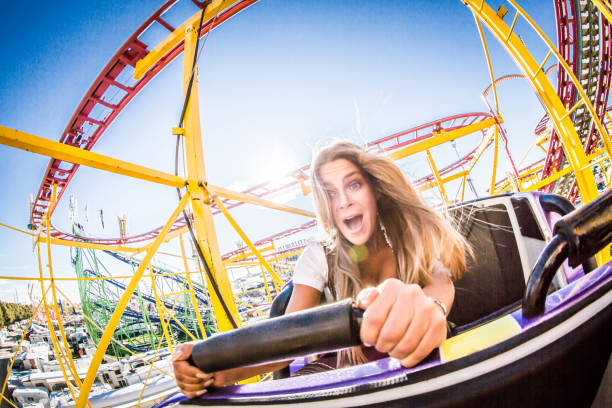 ROLLERCOASTER A girl is taking a ride with a rollercoaster at Beer Fest in Munich / Germany. rollercoaster photos stock pictures, royalty-free photos & images