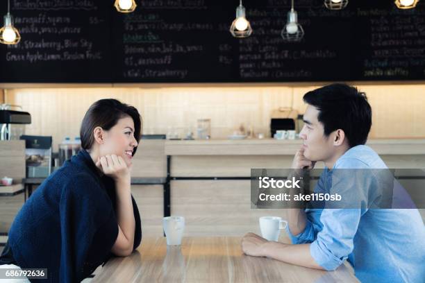 Dating In A Cafe Beautiful Asian Lover Couple Sitting In A Cafe Enjoying In Coffee And Conversation Love And Romance Stock Photo - Download Image Now