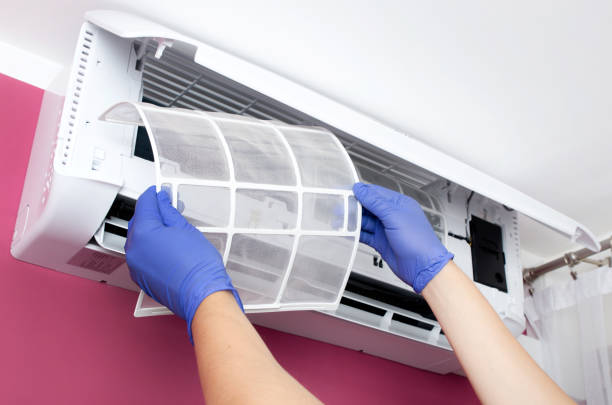 istock Air conditioner cleaning. Man checks the filter. 686792820