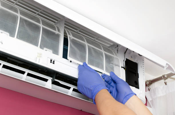 istock Air conditioner cleaning. Man checks the filter. 686792844