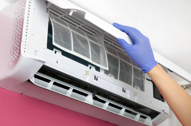 istock Air conditioner cleaning. Man checks the filter. 686792876