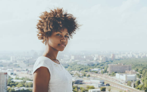 istock Attractive black lady with cityscape in background 686795154