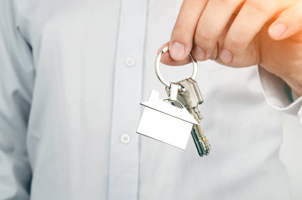 istock Estate agent holding keys to new house 686795190