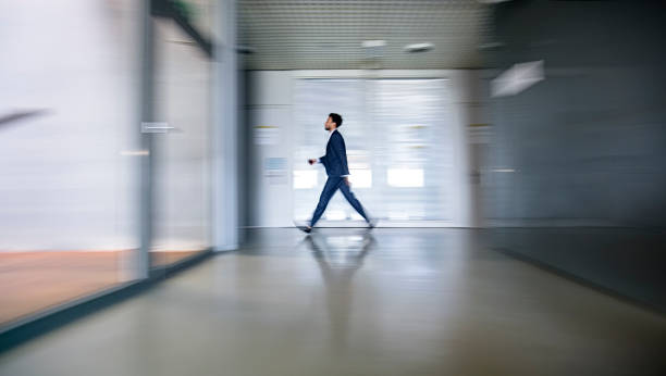 Mixed race businessman in busy workplace