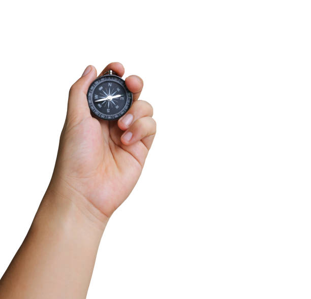 istock hand of a man holding a compass on white background. 686803024