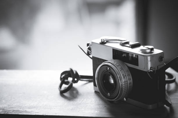 istock Vintage camera film on wood table 686812576