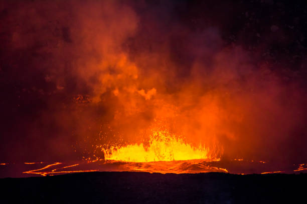 Boiling, erupting lava in the caldera of Kilauea Volcano shoots magma into the air and creates vast amounts of steam from the hot liquid.