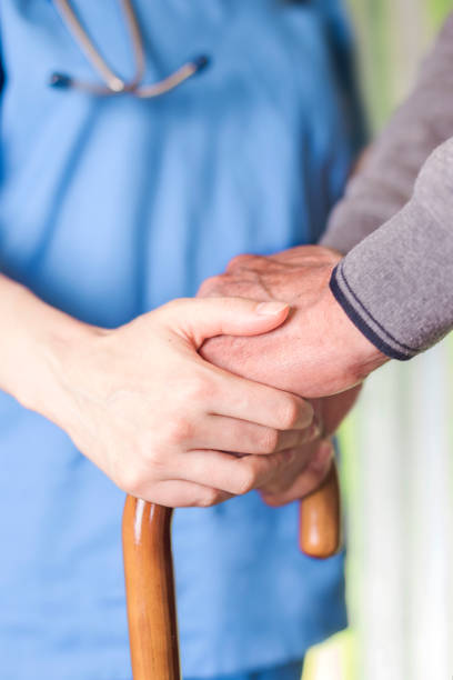 istock Care provider holding senior patient's hand 686822254