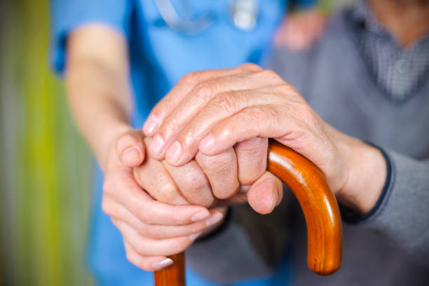 istock Care provider holding senior patient's hand 686822334