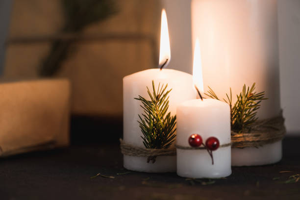 istock Christmas decorations on tha table, lit candles and gifts 686855936
