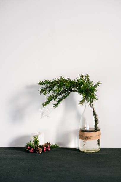 istock Spruce in the bottle and candle on the table Christmas theme 686855956