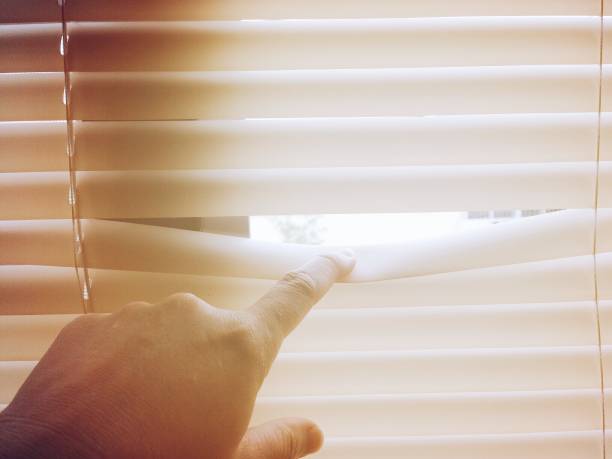 istock Hand open the jalousie and sunlight coming inside 686856518