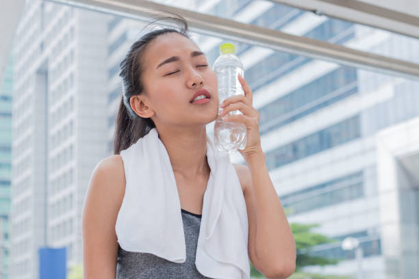istock Woman is drinking a bottle of still water 686856538