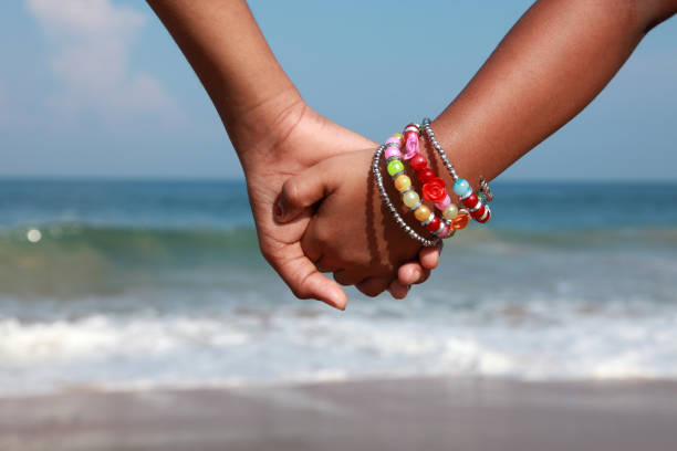 istock Hands of kids hold together in a beach 686866834