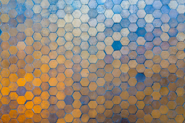 Golden and blue hexagon blocks on the floor. Abstract background texture.