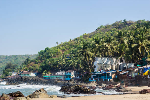 istock Arambol beach with stones, palms and houses, Goa, India 686873112