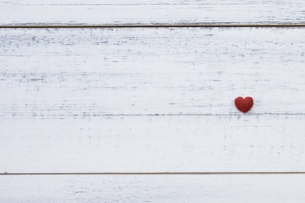 istock One red little hearts on white wood 686876696