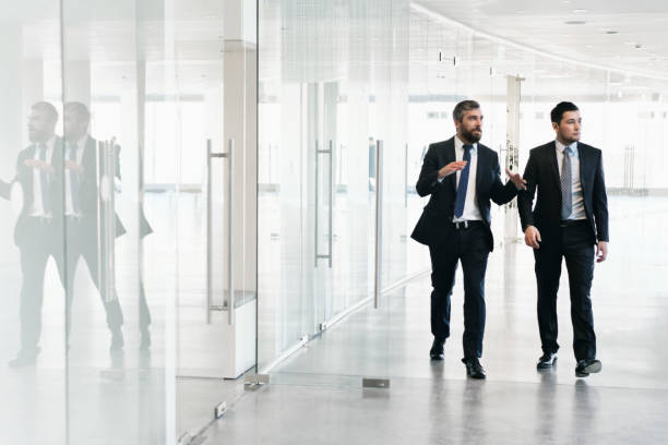 istock Businesspeople Walking Along Office Corridor 686879694