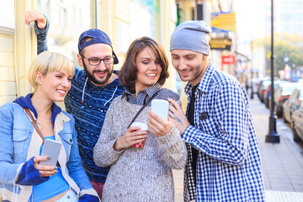 istock Friends using smart phones on street and having fun 686882984