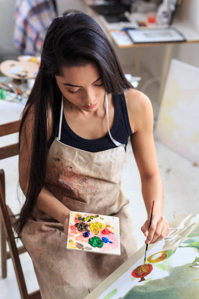 istock Female artist working in her studio 686882994