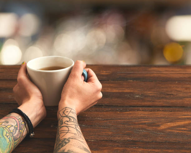 istock woman holding hot cup of tea 686887324
