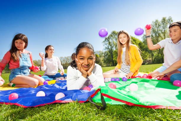 istock Cute African boy laying on colorful mat in park 686889592