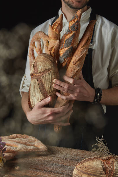 istock Variety of bread hold men's hands 686889780