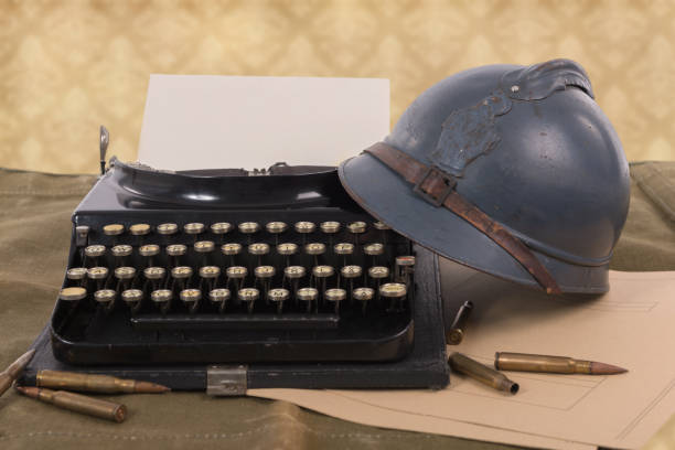 french military helmet of the First World War with old typewriter a french military helmet of the First World War with old typewriter 1914 stock pictures, royalty-free photos & images