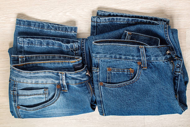 istock New blue jeans on wooden background. 686895982