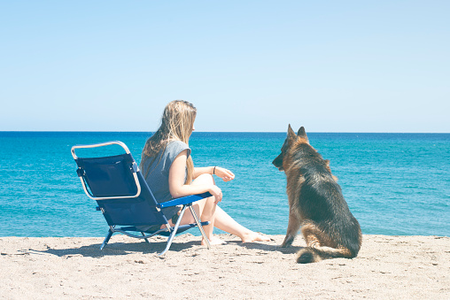 Young chiva with her pet on the beach