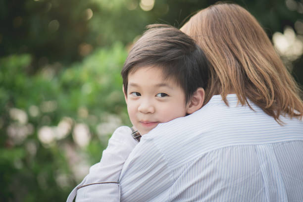 istock asian mother hugging with her son in the park 686898936