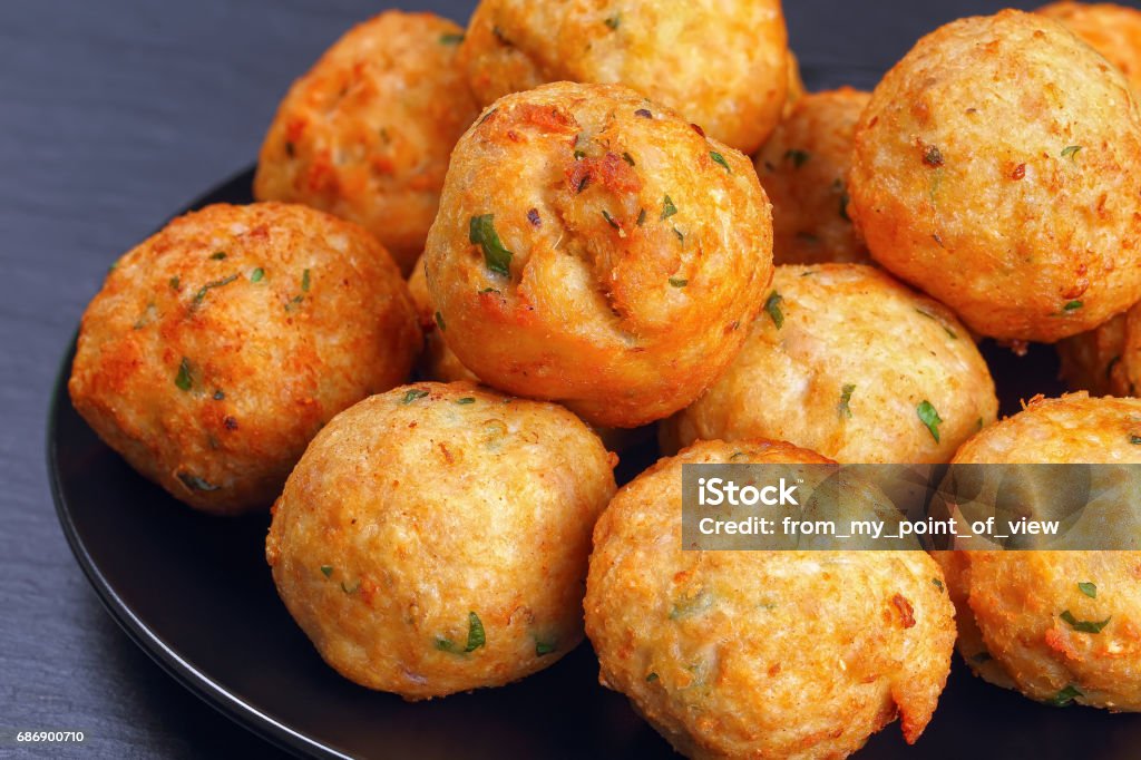 delicious fried meatballs on black plate delicious fried meatballs from ground meat, bread crumbs, spices and parsley on black plate on dark stone tray, classic recipe, close-up, front view from above Appetizer Stock Photo