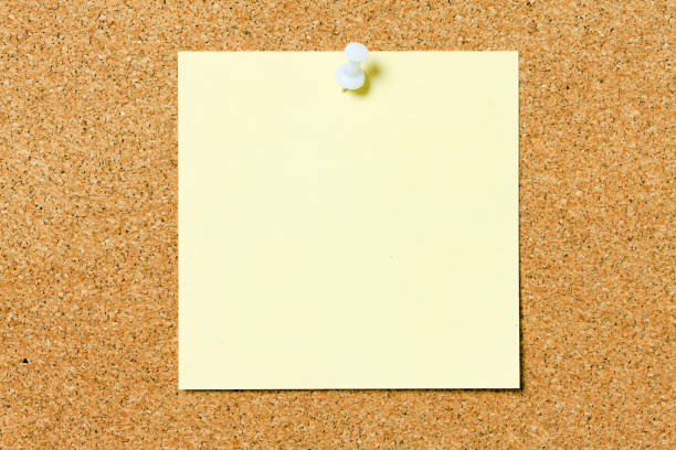 istock Corkboard with blank yellow adhesive note pinned to it 686910572