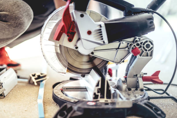 istock man, worker using a sliding compound mitre saw with circular blade for cutting metal and aluminium 686912442