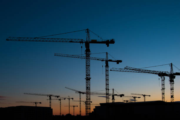 istock many construction cranes on sunset sky , crane silhouette skyline 686917734