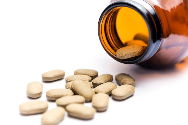 istock Medicine spilling out of a bottle isolated 686925124