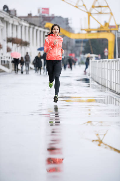 istock Woman jogging after rain 686925444