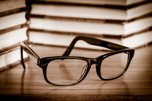 istock Glasses and books on wooden table 686927500